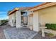 Inviting outdoor seating on brick-paved front porch with glass paneled door, complemented by a bird bath at 1800 Summit Pointe Dr, Las Vegas, NV 89117