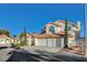 Charming two-story home featuring a terracotta roof, a three-car garage, and manicured landscaping at 1800 Summit Pointe Dr, Las Vegas, NV 89117