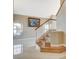 Foyer featuring wood stairs, tile floors, and an art piece, creates a sophisticated entry to the home at 1800 Summit Pointe Dr, Las Vegas, NV 89117