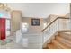 Bright and airy foyer with tile flooring, a staircase, and a red front door, creating a welcoming entrance at 1800 Summit Pointe Dr, Las Vegas, NV 89117