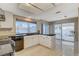 Bright kitchen with stainless appliances, tile counters, and view of backyard patio at 1800 Summit Pointe Dr, Las Vegas, NV 89117