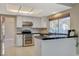 Open kitchen with stainless steel oven, white cabinetry, and tile countertops at 1800 Summit Pointe Dr, Las Vegas, NV 89117