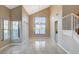 Bright living room featuring tile flooring, vaulted ceiling, and large windows providing ample natural light at 1800 Summit Pointe Dr, Las Vegas, NV 89117