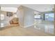 Open-concept living room with tile floors and staircase, adjacent to the kitchen at 1800 Summit Pointe Dr, Las Vegas, NV 89117