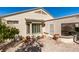 View of the back of the house, which includes a covered patio and low maintenance desert landscaping at 1811 Tiger Creek Ave, Henderson, NV 89012