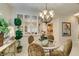 Elegant dining space illuminated by chandelier lighting and large window at 1811 Tiger Creek Ave, Henderson, NV 89012