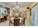 Traditional breakfast nook with ornate chandelier and bright, white-shuttered window at 1811 Tiger Creek Ave, Henderson, NV 89012