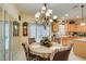 Traditional breakfast nook with ornate chandelier and bright, white-shuttered window at 1811 Tiger Creek Ave, Henderson, NV 89012