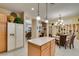 Traditional kitchen with breakfast nook featuring chandelier, shutters, and modern appliances at 1811 Tiger Creek Ave, Henderson, NV 89012