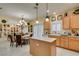 Traditional eat-in kitchen with breakfast nook featuring chandelier, shutters, and modern appliances at 1811 Tiger Creek Ave, Henderson, NV 89012