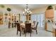 Traditional eat-in kitchen with breakfast nook featuring chandelier, shutters, and modern appliances at 1811 Tiger Creek Ave, Henderson, NV 89012