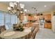 Traditional eat-in kitchen with breakfast nook featuring chandelier, shutters, and modern appliances at 1811 Tiger Creek Ave, Henderson, NV 89012