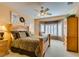 Traditional primary bedroom featuring sitting area, bay windows with shutters, and a ceiling fan at 1811 Tiger Creek Ave, Henderson, NV 89012