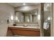 Bathroom with dual sinks, vanity and a huge mirror over the sink at 211 E Flamingo Rd # 1707, Las Vegas, NV 89169