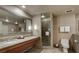 Large bathroom with dual sinks, a huge mirror, and a walk-in shower at 211 E Flamingo Rd # 1707, Las Vegas, NV 89169