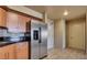 Bright kitchen with stainless steel refrigerator and contrasting black countertops at 211 E Flamingo Rd # 1707, Las Vegas, NV 89169