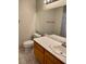 Bathroom featuring a toilet, vanity, sink and mirror with floral shower curtain in background at 2223 Rugged Mesa Dr, Laughlin, NV 89029