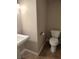 Cozy half bathroom features a pedestal sink and toilet at 2223 Rugged Mesa Dr, Laughlin, NV 89029