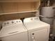 Convenient laundry room setup with washer, dryer, and storage shelves at 2223 Rugged Mesa Dr, Laughlin, NV 89029