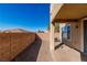 View of the backyard, featuring a covered patio and partial privacy wall at 225 Priority Point St, Henderson, NV 89012