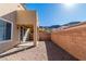 Backyard area featuring a patio space and a tan wall, with a hillside visible at 225 Priority Point St, Henderson, NV 89012