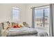 Bedroom featuring a large window, wood floors, and plush bedding at 225 Priority Point St, Henderson, NV 89012