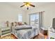 Cozy bedroom features a large window, wood floors, and ceiling fan at 225 Priority Point St, Henderson, NV 89012