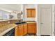 Cozy kitchen featuring wood cabinets, granite countertops, and a double sink at 225 Priority Point St, Henderson, NV 89012