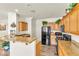 Stylish kitchen with stainless steel appliances, oak cabinets, and granite countertops at 225 Priority Point St, Henderson, NV 89012