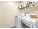 Laundry room with washer, dryer, and storage shelf at 225 Priority Point St, Henderson, NV 89012