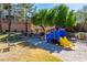 Community playground with train-themed play structure and slide in a landscaped outdoor area at 225 Priority Point St, Henderson, NV 89012