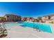 Community pool with crystal-clear water, multiple entries, and nearby residential buildings on a sunny day at 225 Priority Point St, Henderson, NV 89012