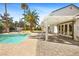 This backyard features a pool, patio, pergola, and large windows at 2301 W El Camino Ave, Las Vegas, NV 89102