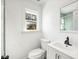 This bathroom features a single sink vanity and a window at 2301 W El Camino Ave, Las Vegas, NV 89102