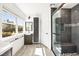 Well-lit bathroom featuring a modern vanity, glass-enclosed shower, and wood-style floors at 2301 W El Camino Ave, Las Vegas, NV 89102