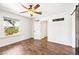 This bedroom features wood-look floors, a ceiling fan, and a large window at 2301 W El Camino Ave, Las Vegas, NV 89102