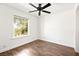 Bright bedroom with wood-look floors, a ceiling fan, and a sun-filled window at 2301 W El Camino Ave, Las Vegas, NV 89102