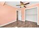 This bedroom has wood-look floors, a ceiling fan, and a closet at 2301 W El Camino Ave, Las Vegas, NV 89102