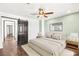 Comfortable bedroom with a ceiling fan, stylish artwork, and a sliding barn door to the closet at 2301 W El Camino Ave, Las Vegas, NV 89102