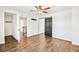 Bright bedroom with wood-look floors, a ceiling fan, and sliding barn door for a modern touch at 2301 W El Camino Ave, Las Vegas, NV 89102