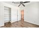 This bedroom features a ceiling fan, wood-look floors, and a closet with shelving at 2301 W El Camino Ave, Las Vegas, NV 89102