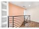 This interior hallway features a metal banister and wood-look floors at 2301 W El Camino Ave, Las Vegas, NV 89102