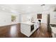 Open floor plan with updated kitchen island featuring quartz countertops and stainless steel appliances at 2301 W El Camino Ave, Las Vegas, NV 89102