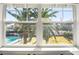 A large window provides a stunning view of the pool and palm trees at 2301 W El Camino Ave, Las Vegas, NV 89102