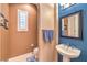 Powder room with blue accent wall, pedestal sink, and tiled floor at 2375 Malaga Peak St, Las Vegas, NV 89135