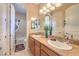 A bright bathroom features double sinks, granite countertops, and modern fixtures for a luxurious feel at 2375 Malaga Peak St, Las Vegas, NV 89135