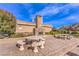 Outdoor common area with stamped concrete, stone fireplace, and concrete tables at 2375 Malaga Peak St, Las Vegas, NV 89135