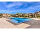 Resort-style community pool area with lounge chairs and blue water under a sunny sky at 2375 Malaga Peak St, Las Vegas, NV 89135