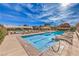 Beautiful community pool area with lounge chairs and clear blue water under a sunny sky at 2375 Malaga Peak St, Las Vegas, NV 89135