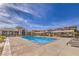 Resort-style community pool area with lounge chairs and blue water under a sunny sky at 2375 Malaga Peak St, Las Vegas, NV 89135